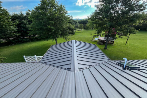 Gray standing seam metal roof installation showcasing precision hip and valley detailing on a home in Cassadaga, NY by MW Home Improvements.