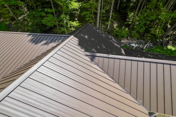 Overhead view of precise valley lines on a dark bronze standing seam metal roof.