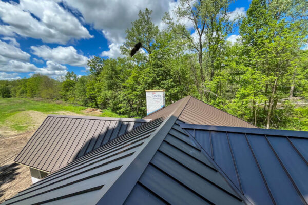 New construction home featuring a custom bronze standing seam metal roof.