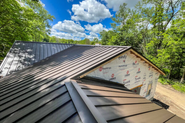 Clean, straight lines of a premium residential standing seam metal roof installation.