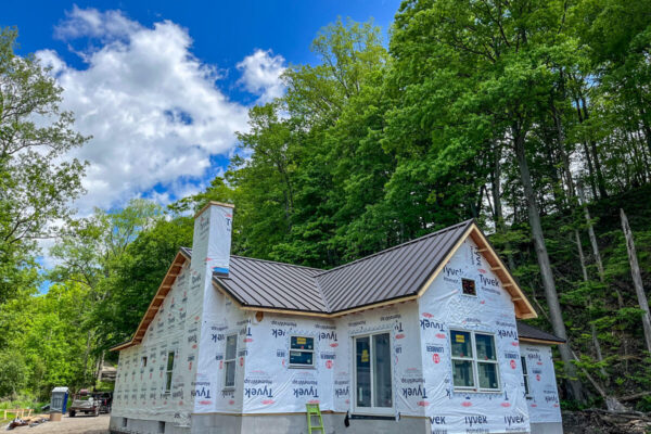 Side profile of a newly installed dark bronze standing seam metal roof.